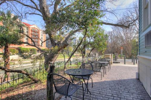 a row of tables and chairs on a sidewalk at Inn on the Riverwalk in San Antonio