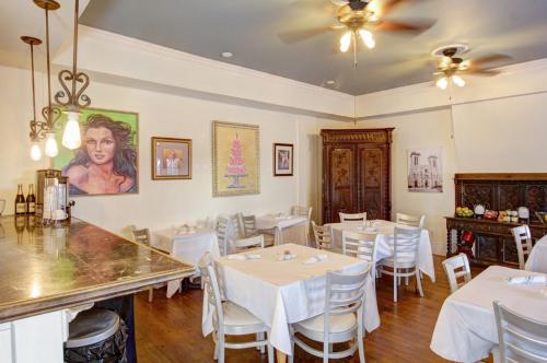 a dining room with white tables and white chairs at Inn on the Riverwalk in San Antonio