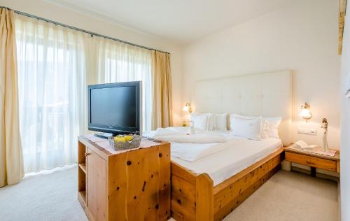 Ένα ή περισσότερα κρεβάτια σε δωμάτιο στο Hotel Ansitz Plantiz