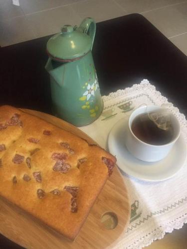 a table with a piece of cake and a cup of coffee at Hotel do Lago in Toledo