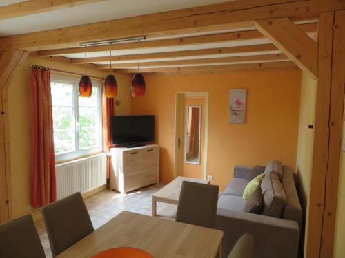 a living room with a couch and a table at Gîte La Pierre Qui Tourne in Amboise