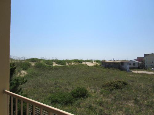 a view of a grassy hill with houses on it at Surf Side Hotel in Nags Head