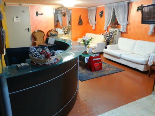 a living room with a counter in the middle of a room at Hotel Arcella in Padova