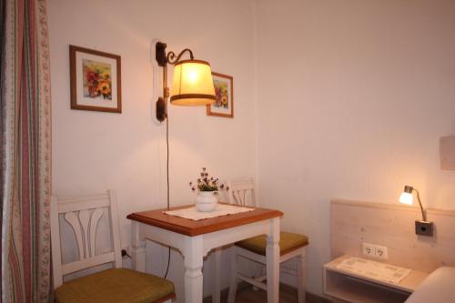 a small bathroom with a sink and a lamp at Hotel Villa Sisi in Pöcking