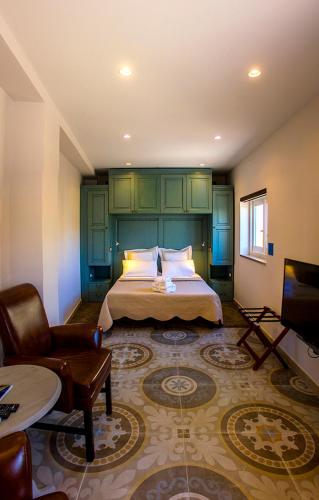 a bedroom with a bed and a living room at Casa Azzopardi Suites in Rabat