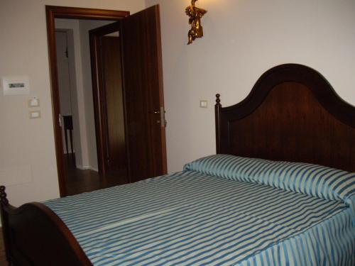 a bedroom with a bed with a blue and white stripes at Agriturismo Il Borgo Degli Ulivi in Roseto degli Abruzzi