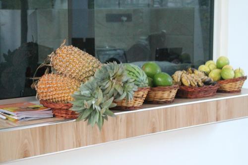 a display of fruits and vegetables in baskets on a counter at Green Ocean Bay in Arugam Bay