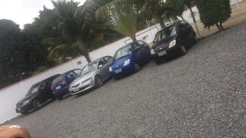 a row of cars parked next to a wall at Hotel Kemarios in Tonsupa