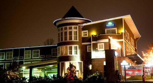 a large building with a sign on the side of it at Days Inn by Wyndham Surrey in Surrey