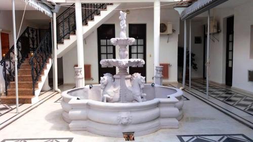 a white fountain in the middle of a building at Hotel Alemán in Gualeguaychú