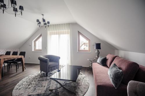 a living room with a couch and a table at Apartments Villa Tatiana in Bled