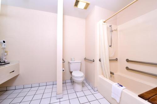 a white bathroom with a toilet and a shower at Americas Best Value Inn Sullivan in Sullivan