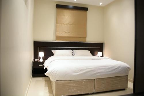 Ένα ή περισσότερα κρεβάτια σε δωμάτιο στο MJ Apartments