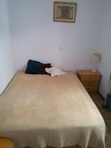 a bed in a white room with at Casa Roja in Las Palmas de Gran Canaria