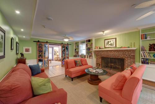 a living room with two couches and a fireplace at The Grey Owl Inn in Saint Simons Island