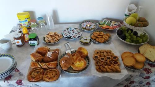 a table topped with lots of different types of food at B&b la valletta in Serravalle Scrivia