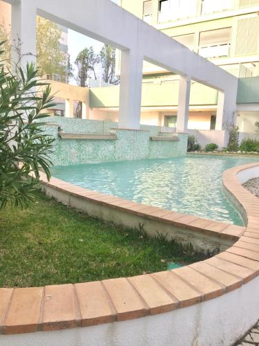 a swimming pool in front of a building at Apartment with Private Terrace & Car Garage in Lisbon