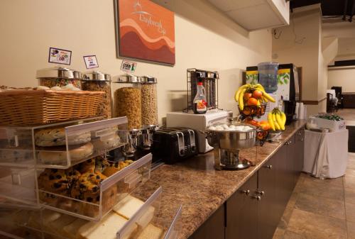 a kitchen with a counter with a bunch of food at Days Inn by Wyndham Surrey in Surrey