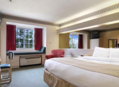 a hotel room with two beds and a television at Stay Express inn and Suites Atlanta Union City in Union City