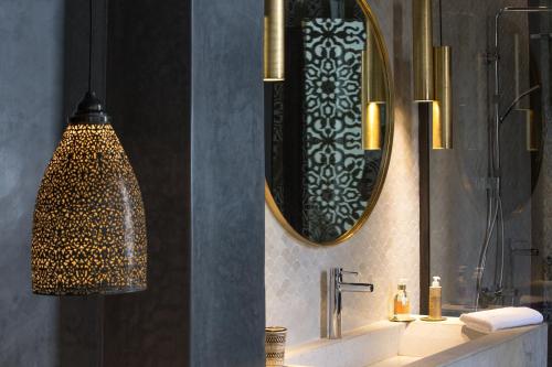 a bathroom with a sink and a mirror at Dar Kandi in Marrakech