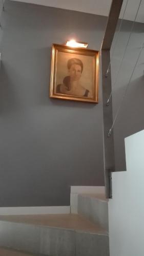 a painting of a woman on a wall with stairs at TOLETUM low cost LOFTS diáfanos o 2dormitorios PARKING Municipal Gratis al aire libre a 100m in Toledo