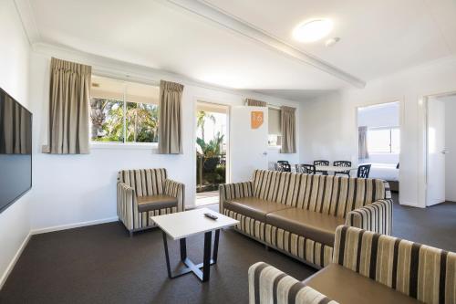 a living room with a couch and chairs and a table at Nightcap at Golden Beach Tavern in Caloundra