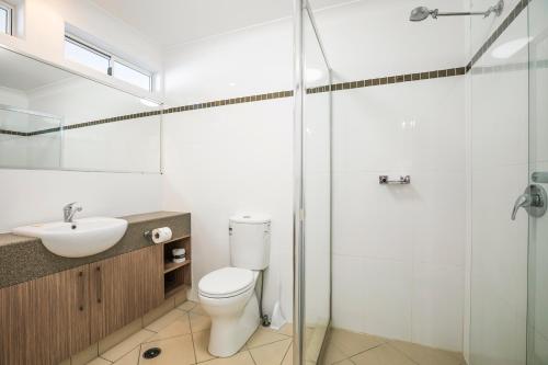 a bathroom with a toilet and a sink and a shower at Nightcap at Golden Beach Tavern in Caloundra
