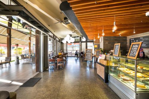 a bakery with a counter and tables and chairs at Nightcap at Golden Beach Tavern in Caloundra