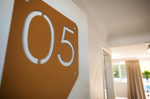 a sign with the number on a wall at Nightcap at Golden Beach Tavern in Caloundra