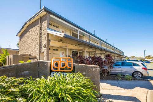 an orange sign in front of a building at Nightcap at Golden Beach Tavern in Caloundra