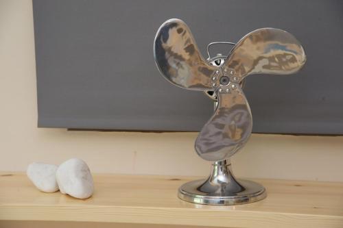 a metal fan sitting on top of a table at G.Living 365 in Ayia Evfimia