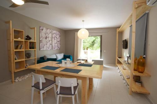 a kitchen and dining room with a table and chairs at G.Living 365 in Ayia Evfimia