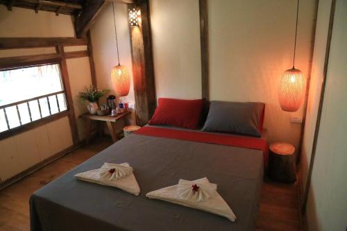 a bedroom with a bed with two towels on it at Puluong Home in Pu Luong