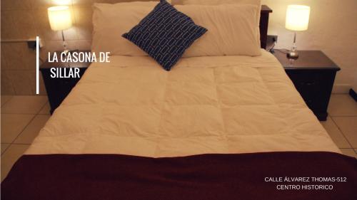 a large bed with white sheets and pillows on it at Casona de Sillar in Arequipa
