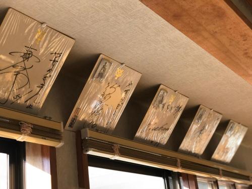 a row of clocks on a wall above a window at Fureai No Yado Yasuragi in Nozawa Onsen