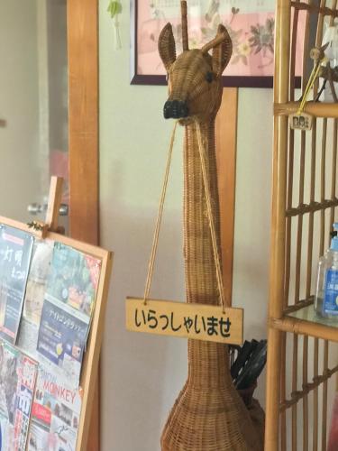 a gazelle toy with a sign that reads at Fureai No Yado Yasuragi in Nozawa Onsen