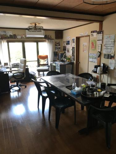 an office with a large table and chairs in a room at Kizuna no Ie in Uozu