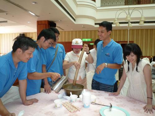 a group of people standing around a table at Life Leisure Resort in Guanxi
