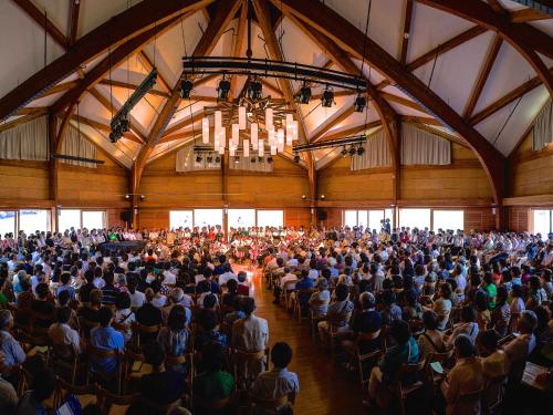 a large crowd of people sitting in a large hall at Okushiga Kogen Hotel in Yamanouchi