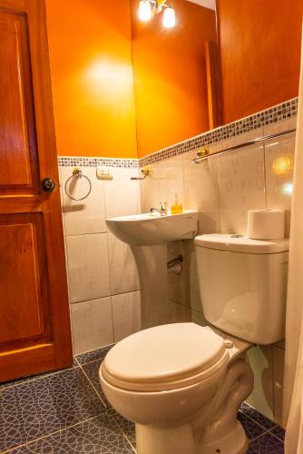 a bathroom with a toilet and a sink at Peru Quechua's Lodge Ollantaytambo in Ollantaytambo