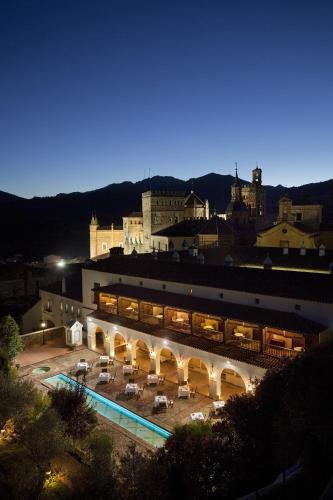 a large building with a courtyard with tables and chairs at Parador de Guadalupe in Guadalupe