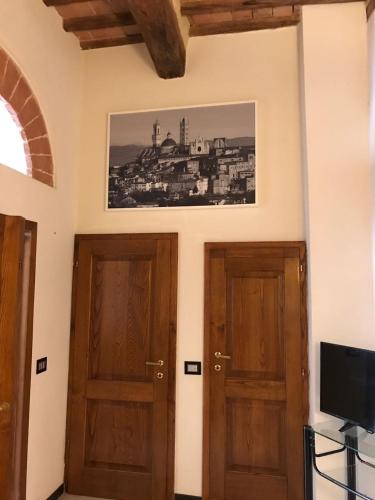 two doors in a room with a picture on the wall at Nonna Anna in Siena