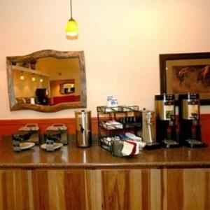 a counter in a hotel room with a mirror at Trails End Motel Sheridan in Sheridan