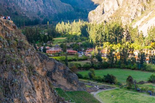 a village in a valley between two mountains at Peru Quechua's Lodge Ollantaytambo in Ollantaytambo