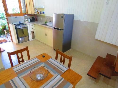 a kitchen with a table and a stainless steel refrigerator at Boulevard 251 Riverside Apartments in Iquitos