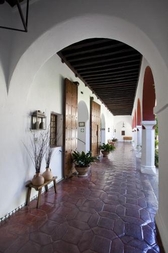 an archway in a building with potted plants at Parador de Guadalupe in Guadalupe