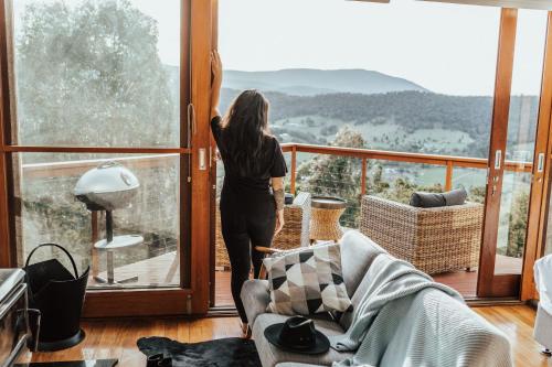 a woman looking out the window of a house at Kangaroo Ridge Retreat in Healesville