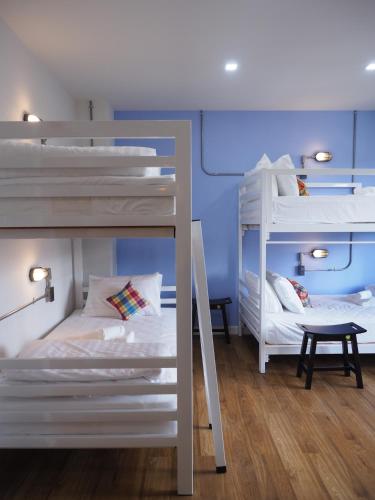 a room with two bunk beds and a table at Luck Esan Loft in Ubon Ratchathani