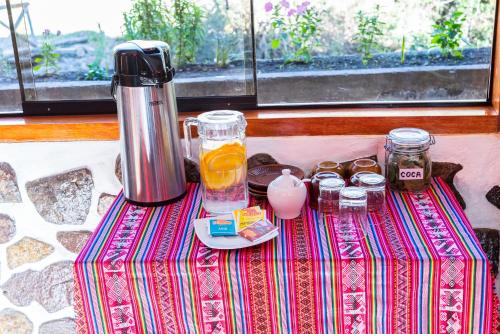 a table with a blender on top of a table at Peru Quechua's Lodge Ollantaytambo in Ollantaytambo
