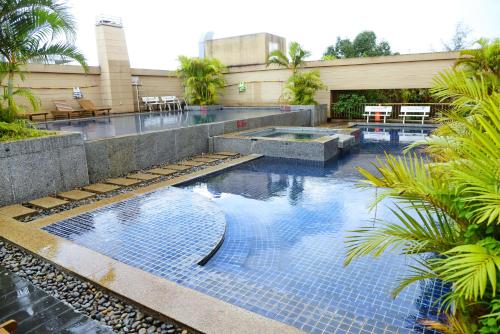 a swimming pool with blue tiles in a building at Sai Gon Ban Me Hotel in Buon Ma Thuot